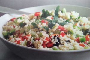 cous cous salad in a bowl with a fork
