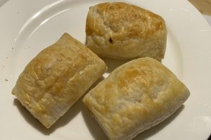 three small chicken sausage rolls on a plate